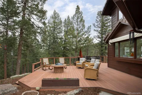 a view of a patio with a table chairs and backyard