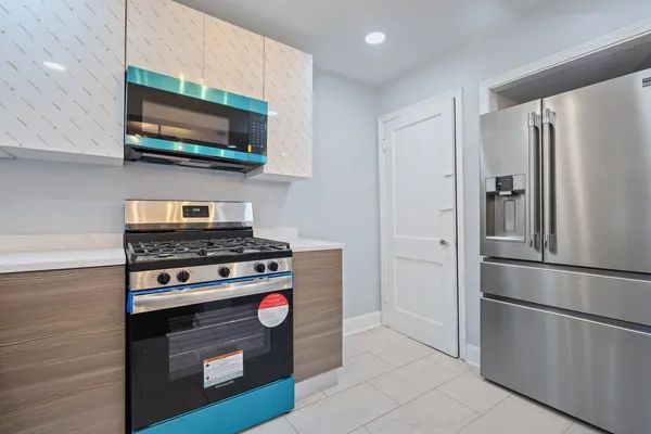 a kitchen with stainless steel appliances granite countertop a stove and a microwave