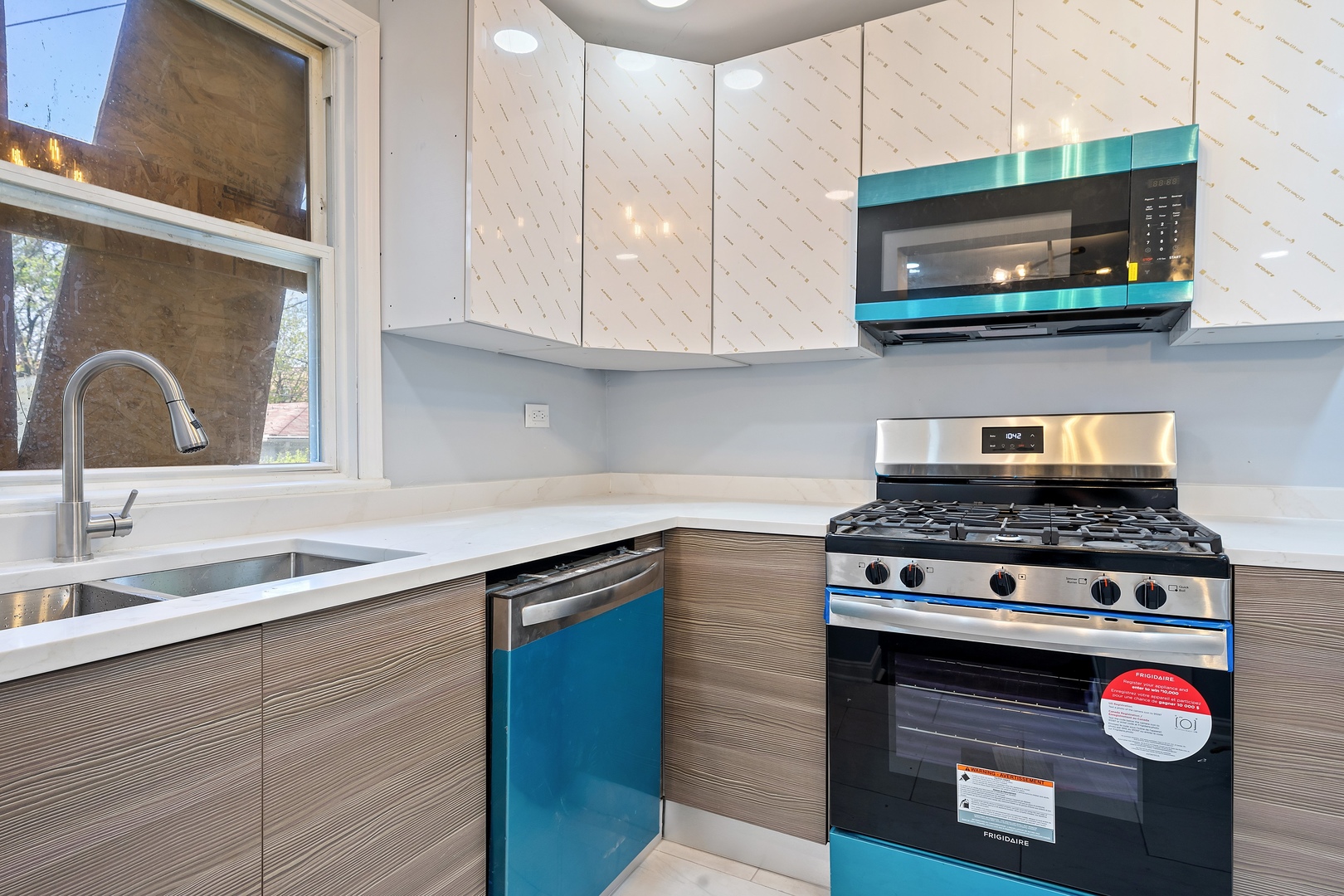 715 East 105th Place Chicago, IL 60628 - Photo 21 of 26 a kitchen with stainless steel appliances granite countertop a stove a sink and a microwave