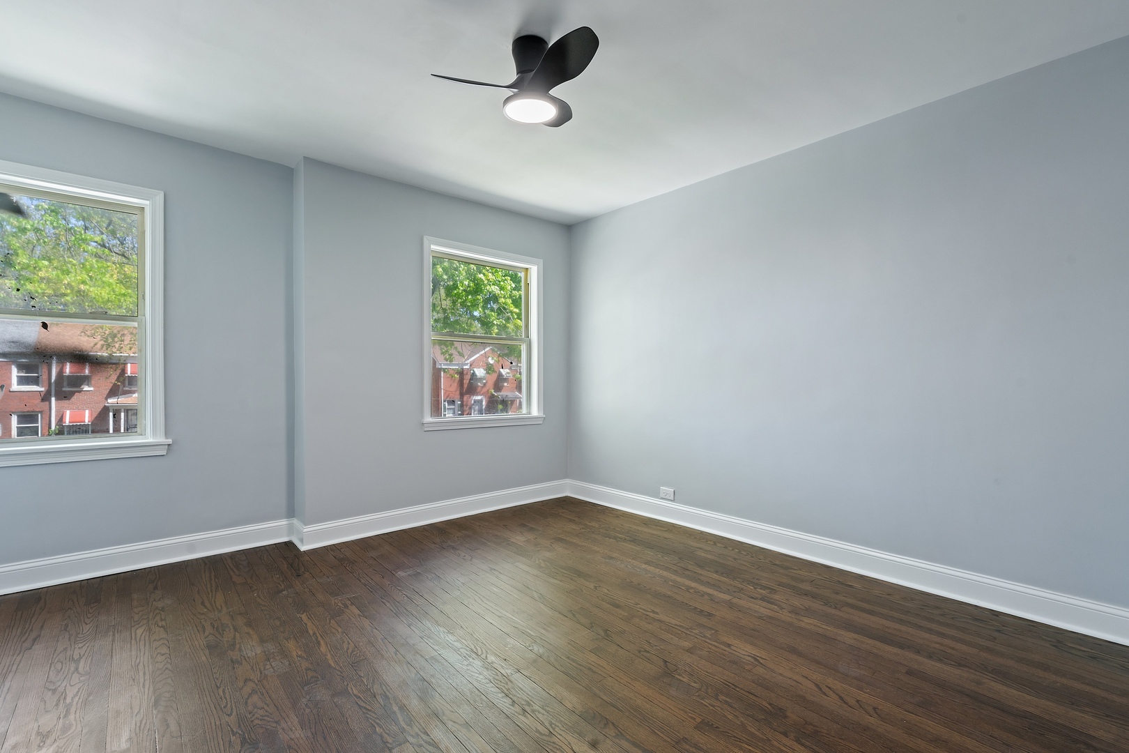 715 East 105th Place Chicago, IL 60628 - Photo 25 of 26 a view of an empty room with wooden floor and a window
