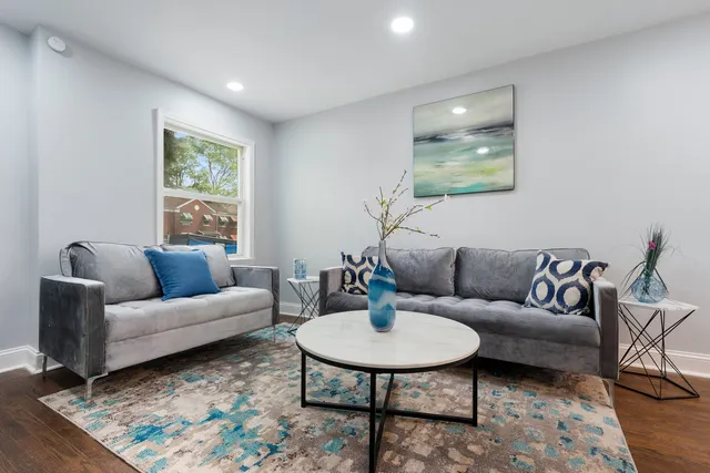 a living room with furniture and a wooden floor