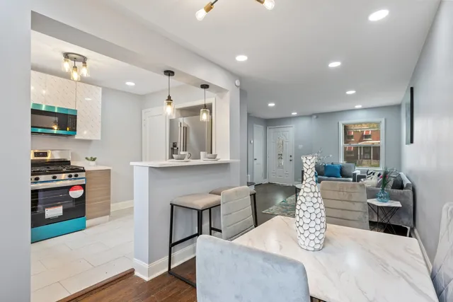 a kitchen with stainless steel appliances granite countertop a refrigerator a sink and a refrigerator