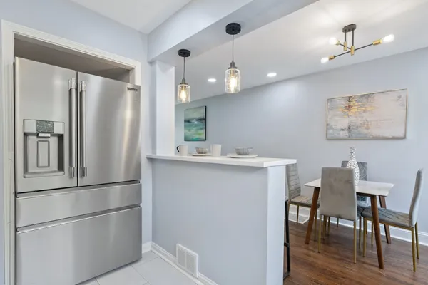 a kitchen with cabinets and chairs