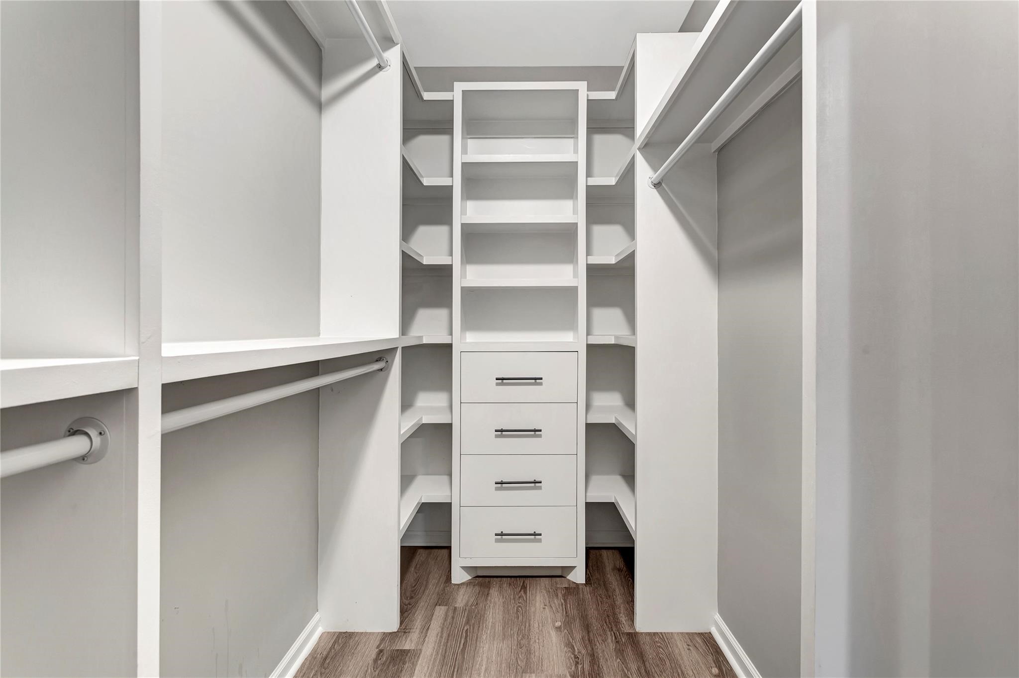 6813 Liverpool Street, Unit B Houston, TX 77021 - Photo 6 of 9 Custom built-ins with floor-to-ceiling shelving, double hanging rods, and a built-in 4-drawer dresser