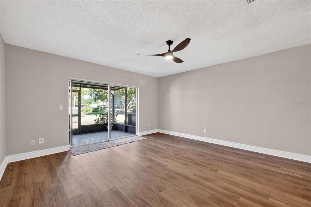 2464 Enterprise Road, Unit 3 Clearwater, FL 33763 - Photo 12 of 29 a view of an empty room with wooden floor and a window
