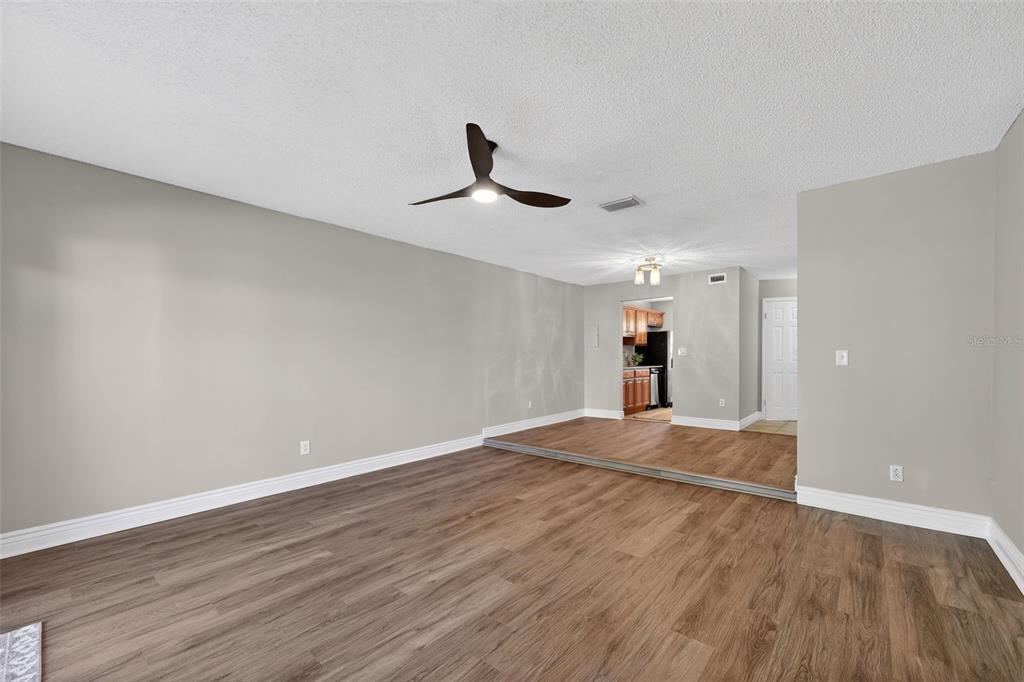 2464 Enterprise Road, Unit 3 Clearwater, FL 33763 - Photo 14 of 29 a view of empty room with wooden floor and ceiling fan
