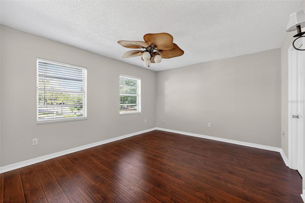 2464 Enterprise Road, Unit 3 Clearwater, FL 33763 - Photo 16 of 29 a view of room with window ceiling fan and hardwood floor