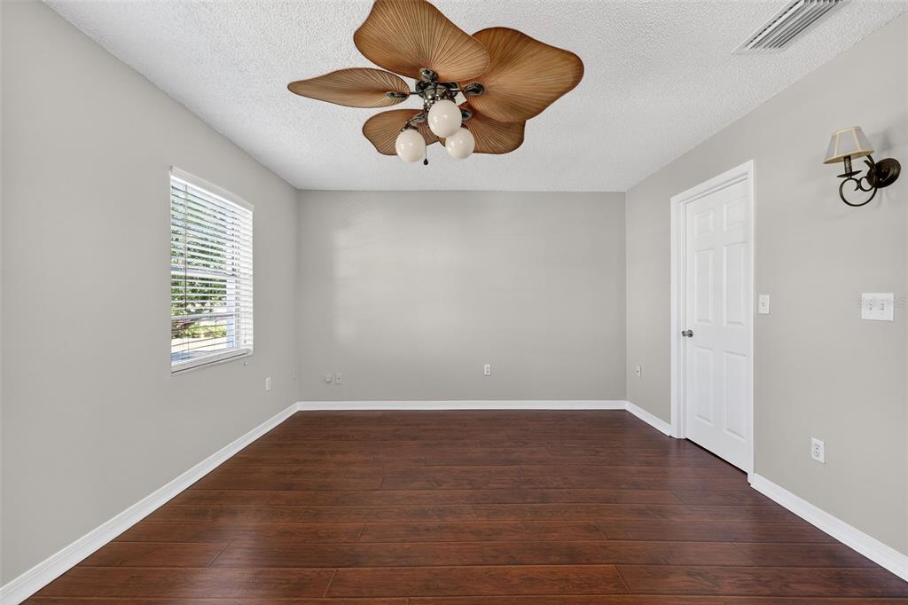 2464 Enterprise Road, Unit 3 Clearwater, FL 33763 - Photo 18 of 29 wooden floor in an empty room with a window