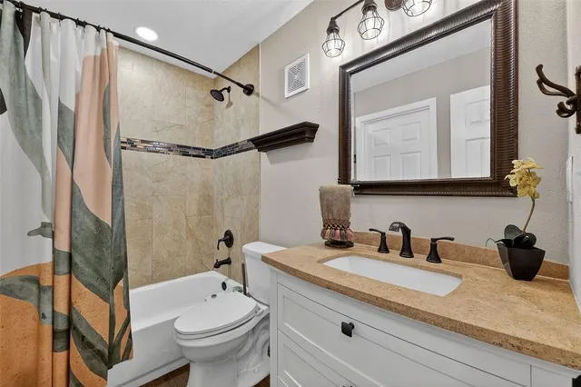a bathroom with a double vanity sink mirror and toilet