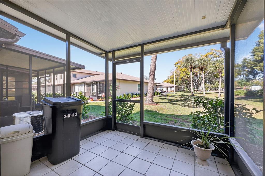 2464 Enterprise Road, Unit 3 Clearwater, FL 33763 - Photo 22 of 29 a living room with furniture and large windows