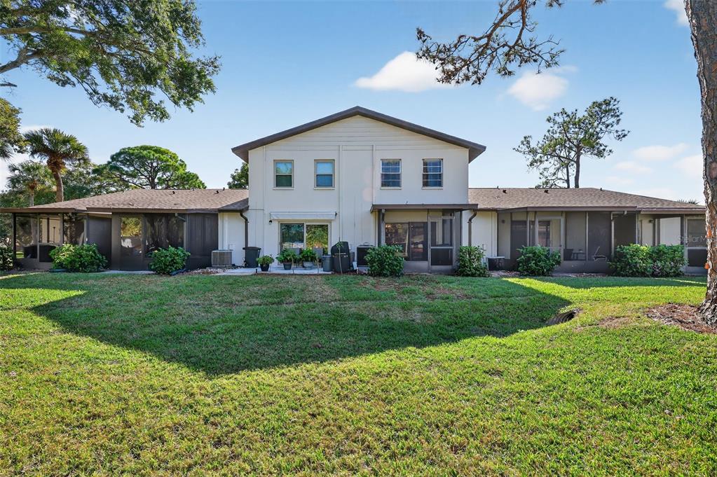 2464 Enterprise Road, Unit 3 Clearwater, FL 33763 - Photo 24 of 29 a view of a house with a yard and a garden
