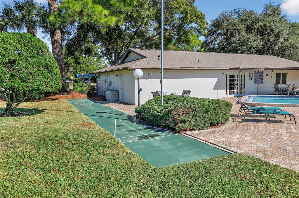 2464 Enterprise Road, Unit 3 Clearwater, FL 33763 - Photo 27 of 29 a backyard of a house with yard and outdoor seating