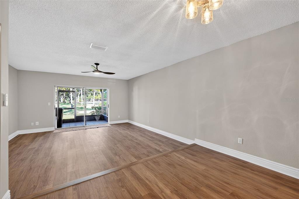 2464 Enterprise Road, Unit 3 Clearwater, FL 33763 - Photo 10 of 29 an empty room with wooden floor and windows