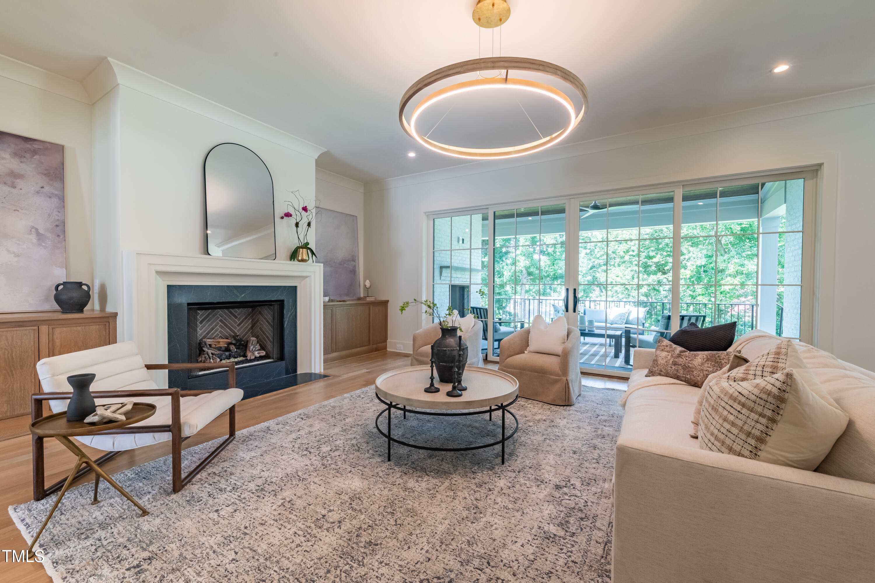 2227 Wheeler Road Raleigh, NC 27607 - Photo 12 of 56 a living room with furniture a fireplace and a large window