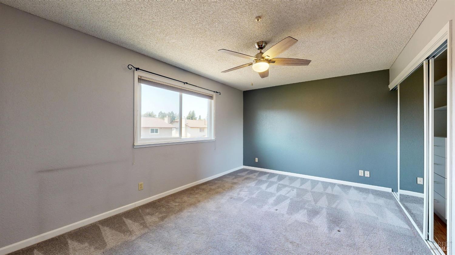 4571 Harbor Lane Rohnert Park, CA 94928 - Photo 31 of 79 an empty room with windows and fan