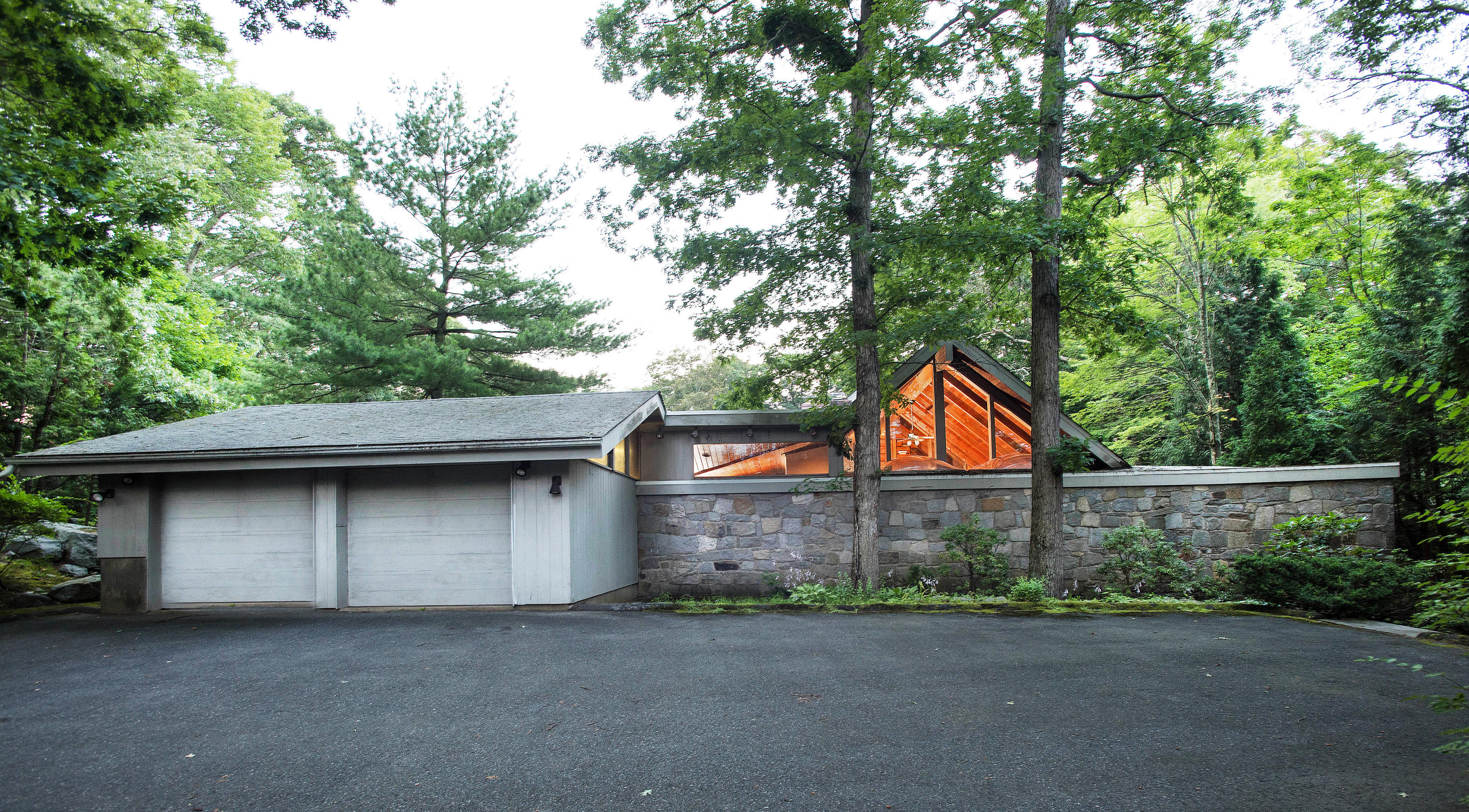 243 Smith Ridge Road New Canaan, CT 06840 - Photo 29 of 29 a front view of house with yard and trees in the background