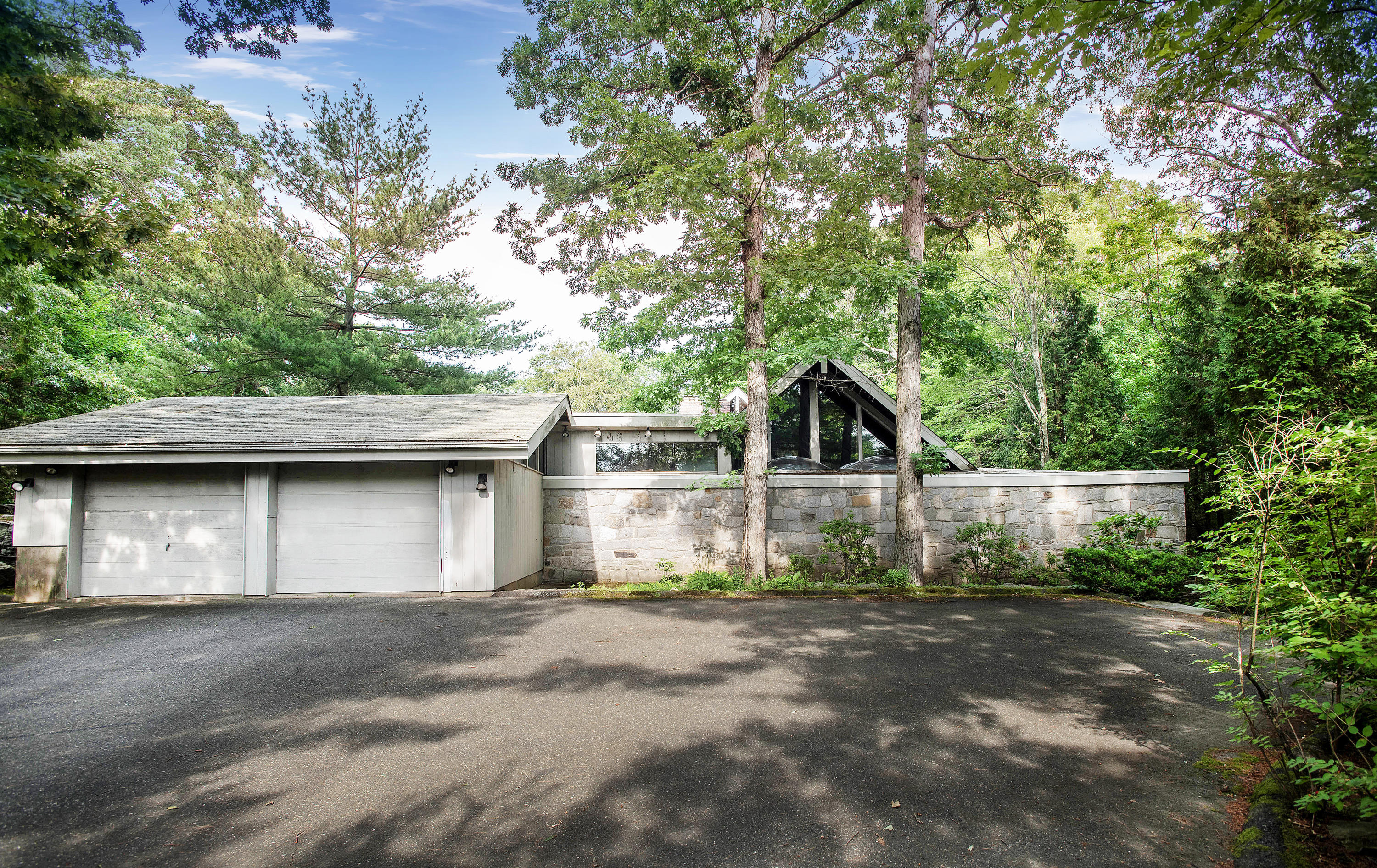 243 Smith Ridge Road New Canaan, CT 06840 - Photo 3 of 29 a front view of a house with a yard