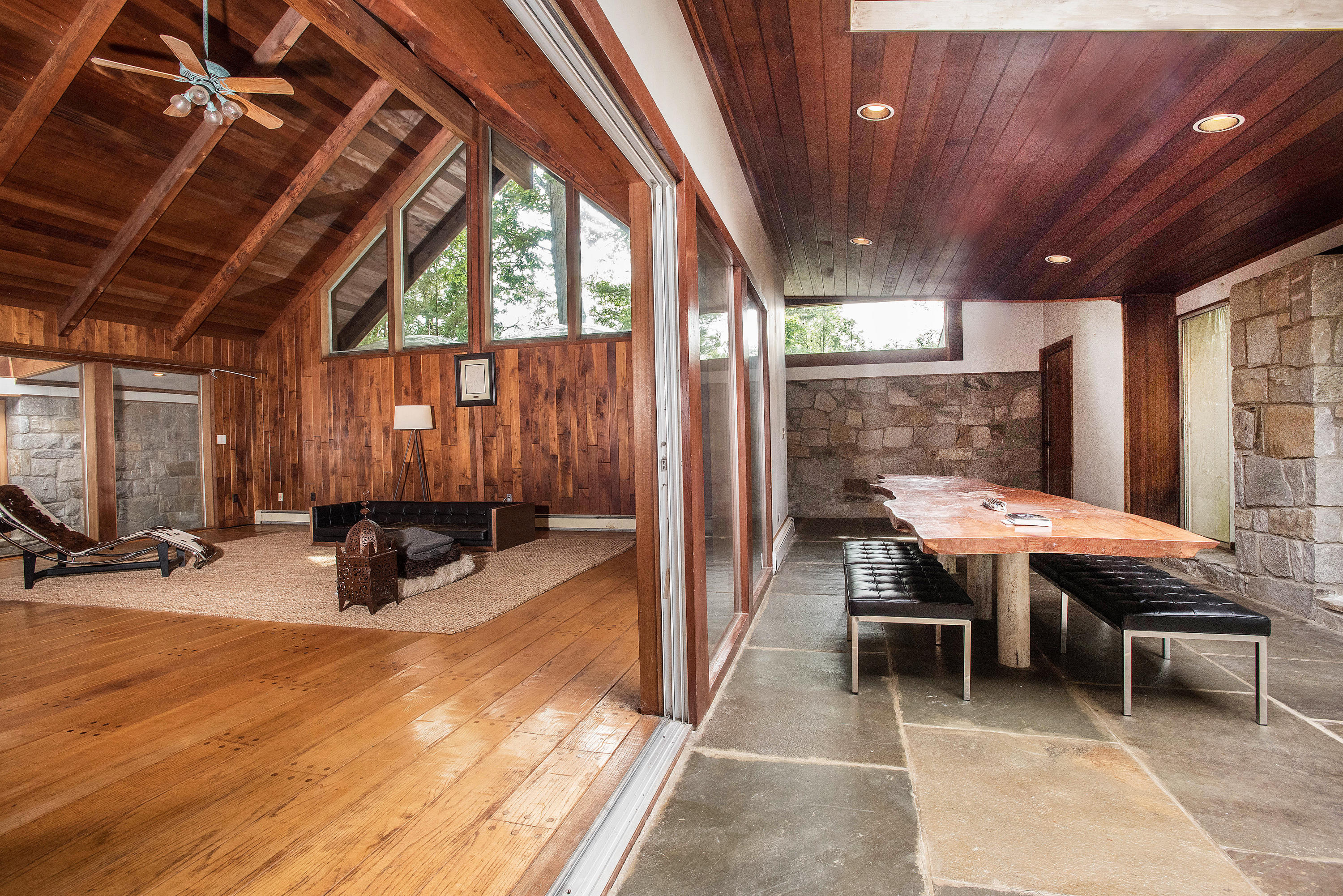 243 Smith Ridge Road New Canaan, CT 06840 - Photo 10 of 29 a view of a patio with table and chairs with wooden floor and fence