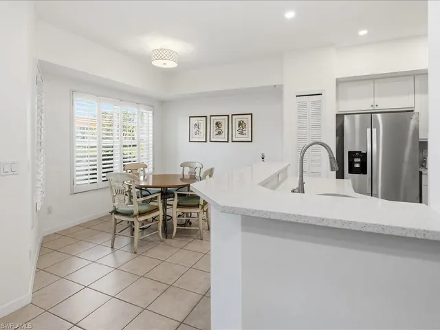 a kitchen with stainless steel appliances a sink and a refrigerator