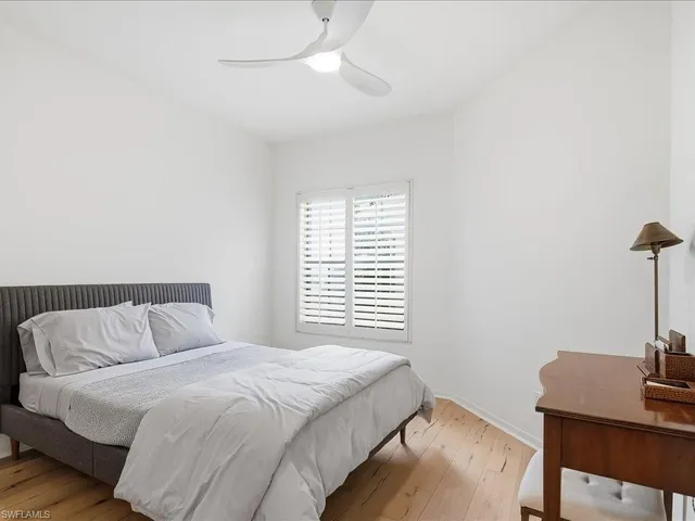 a bedroom with a bed and a desk