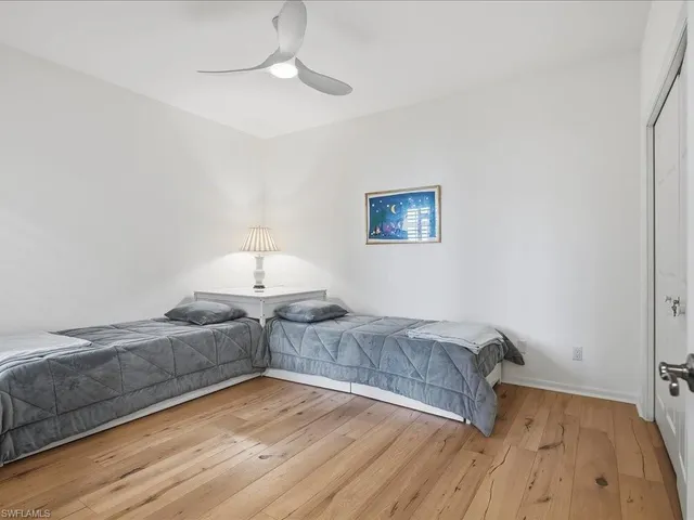 a living room with couch and a night stand