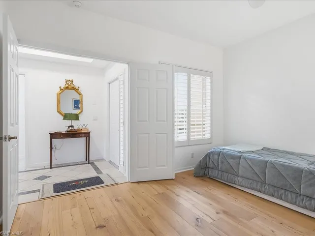a bedroom with a bed and a dresser next to it