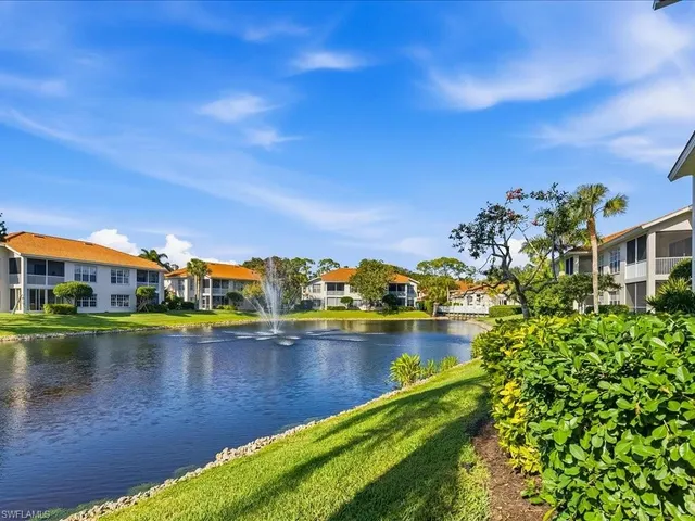 a view of a lake with a house in the background