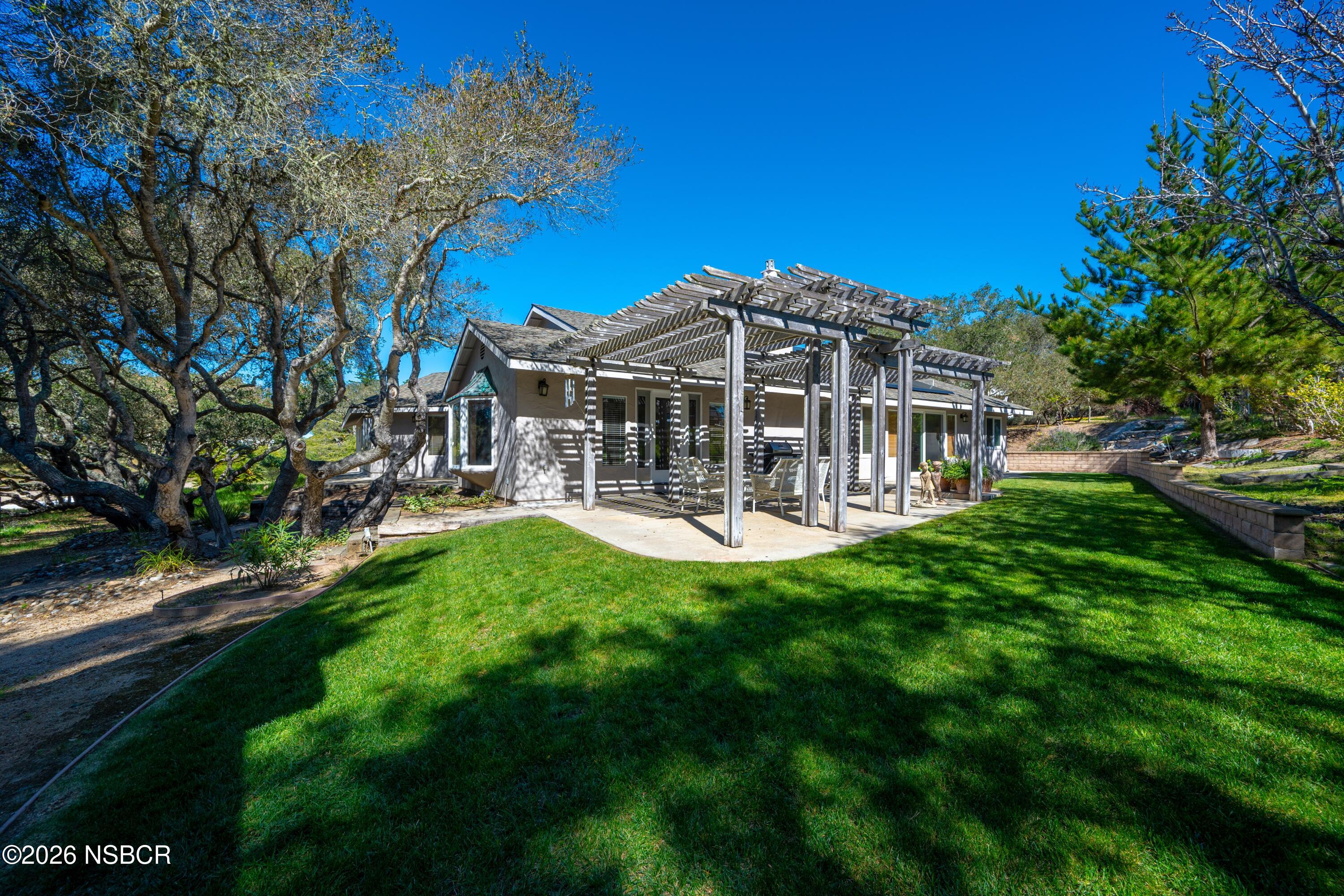 4473 Greenbrier Road Lompoc, CA 93436 - Photo 40 of 54 a view of a house with a backyard porch and sitting area