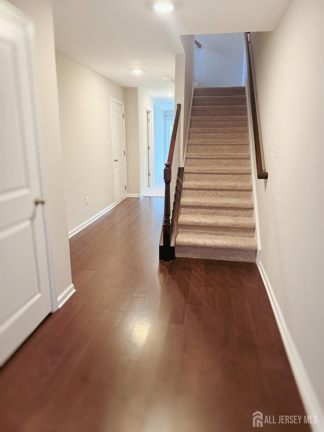 an entryway in a room with wooden floor