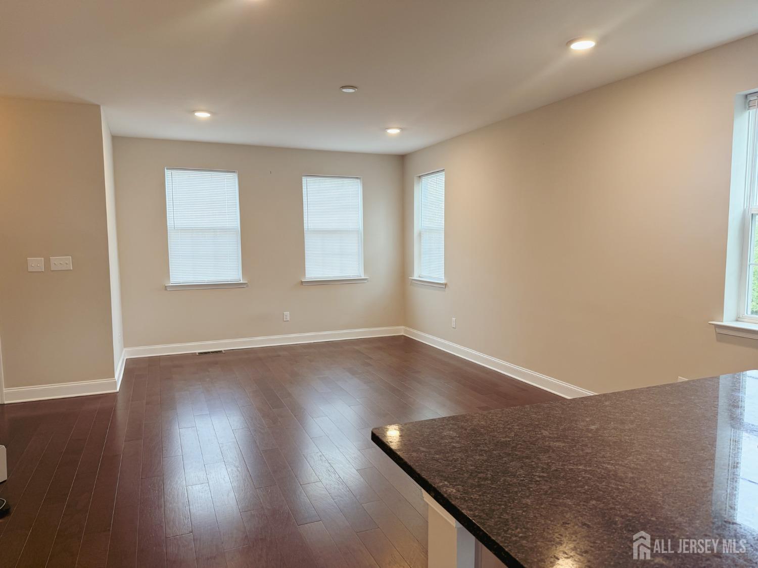 1101 Hights Farm Road North Monroe Township, NJ 08831 - Photo 11 of 38 an empty room with wooden floor and windows