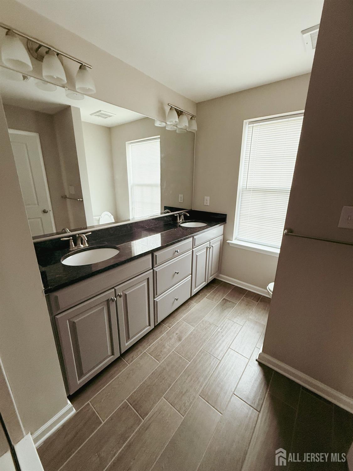 1101 Hights Farm Road North Monroe Township, NJ 08831 - Photo 22 of 38 a kitchen with granite countertop a stove sink and cabinets