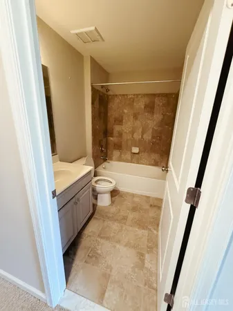 a bathroom with a tub shower and a sink