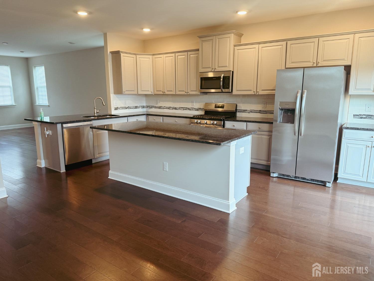 1101 Hights Farm Road North Monroe Township, NJ 08831 - Photo 10 of 38 a kitchen with stainless steel appliances granite countertop a refrigerator a stove a sink and a microwave
