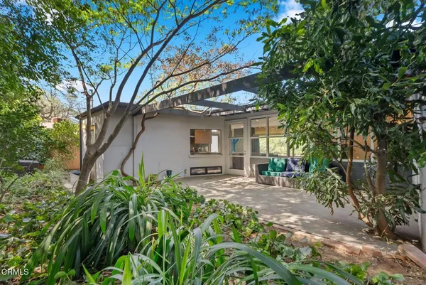 a view of a house with a tree in the yard