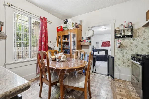 a dining room with furniture and window