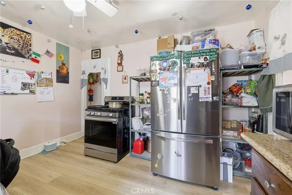 a kitchen with stainless steel appliances granite countertop a refrigerator and a sink