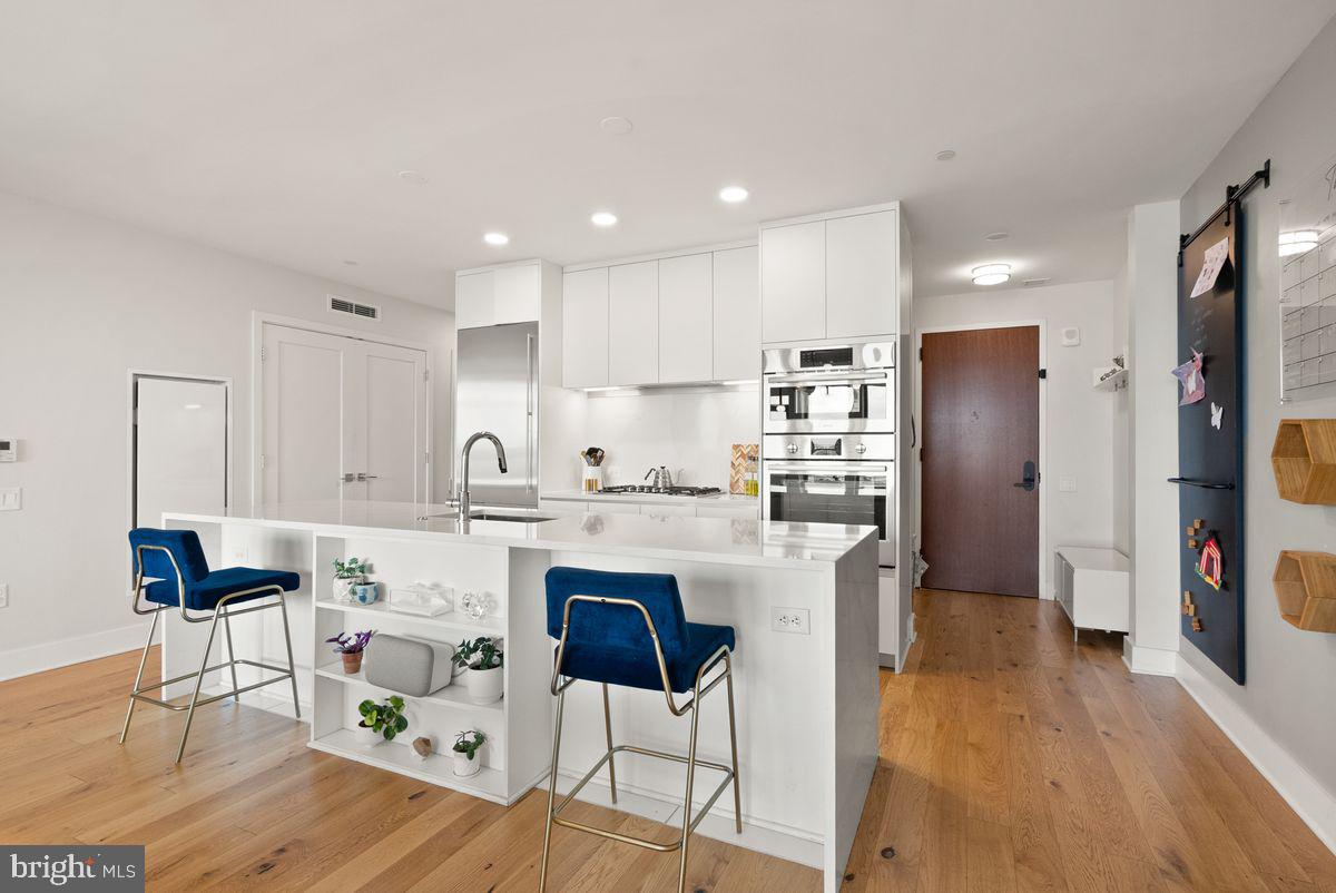 1211 Van Street Southeast, Unit PH13B Washington, DC 20003 - Photo 11 of 25 a kitchen with stainless steel appliances granite countertop a refrigerator and a stove top oven