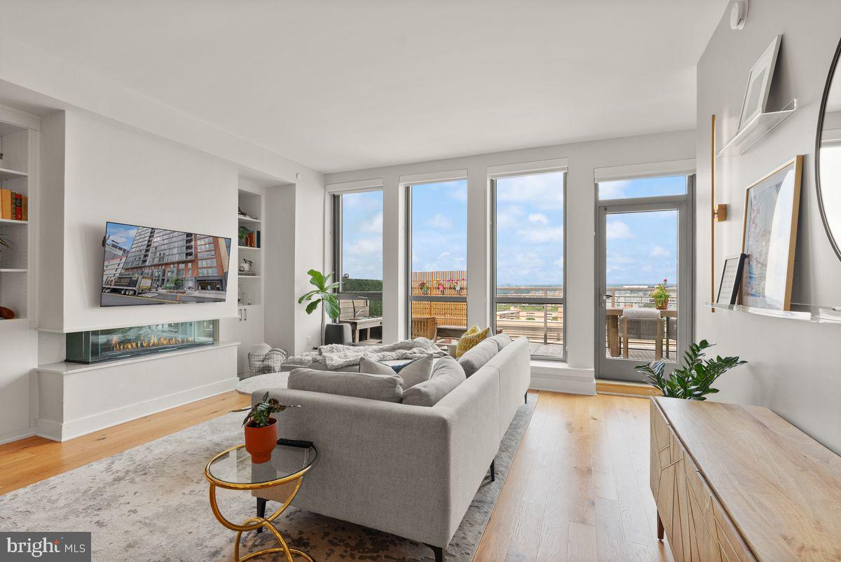 1211 Van Street Southeast, Unit PH13B Washington, DC 20003 - Photo 2 of 25 a living room with furniture and a large window