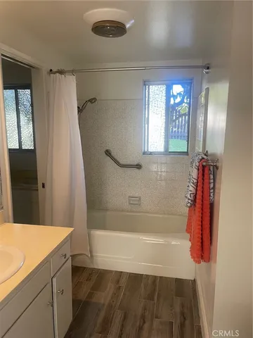 a bathroom with a bathtub and a shower