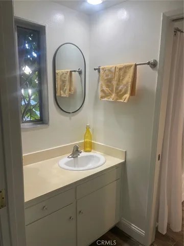 a bathroom with a sink mirror and vanity