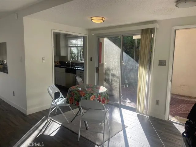 a view of a hallway with dining area and glass door