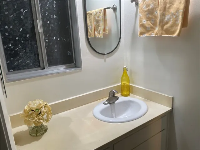 a bathroom with a sink vanity and a mirror