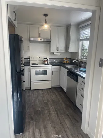 a kitchen with a sink stove and refrigerator