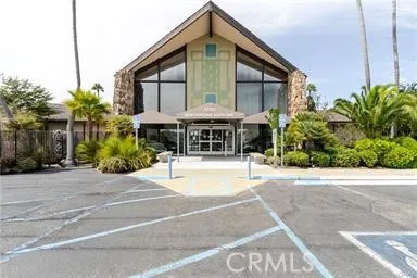 a front view of a house with a yard and potted plants