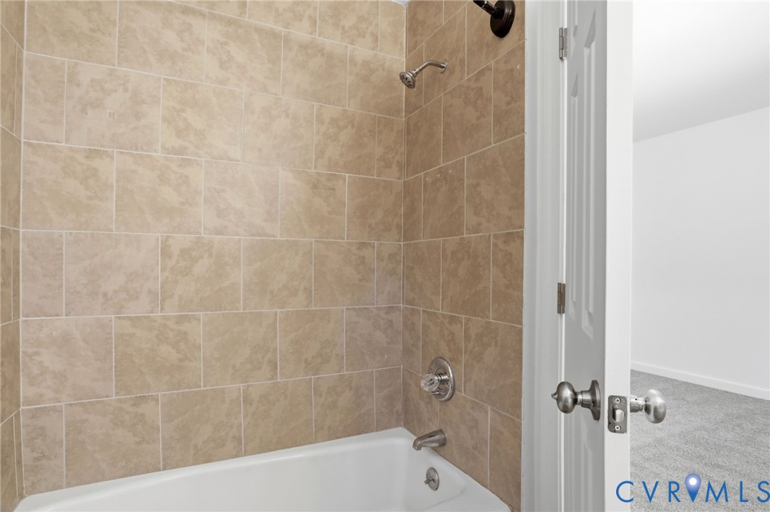 13913 Barnes Spring Road Midlothian, VA 23112 - Photo 27 of 51 Tub and shower combination featuring earth-toned r