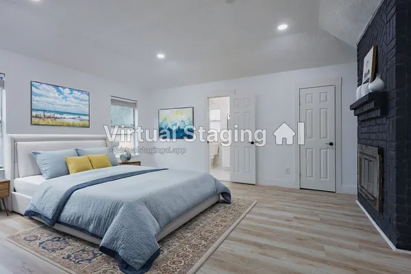 a view of empty room with wooden floor and fireplace