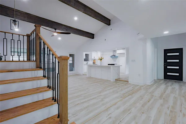 a view of an entryway with wooden floor