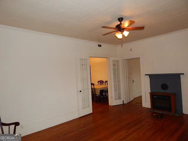 a view of a livingroom with a hardwood floor and a ceiling fan