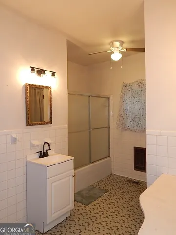 a bathroom with a sink a mirror and shower