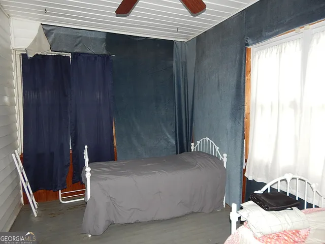 a bedroom with a bed and window